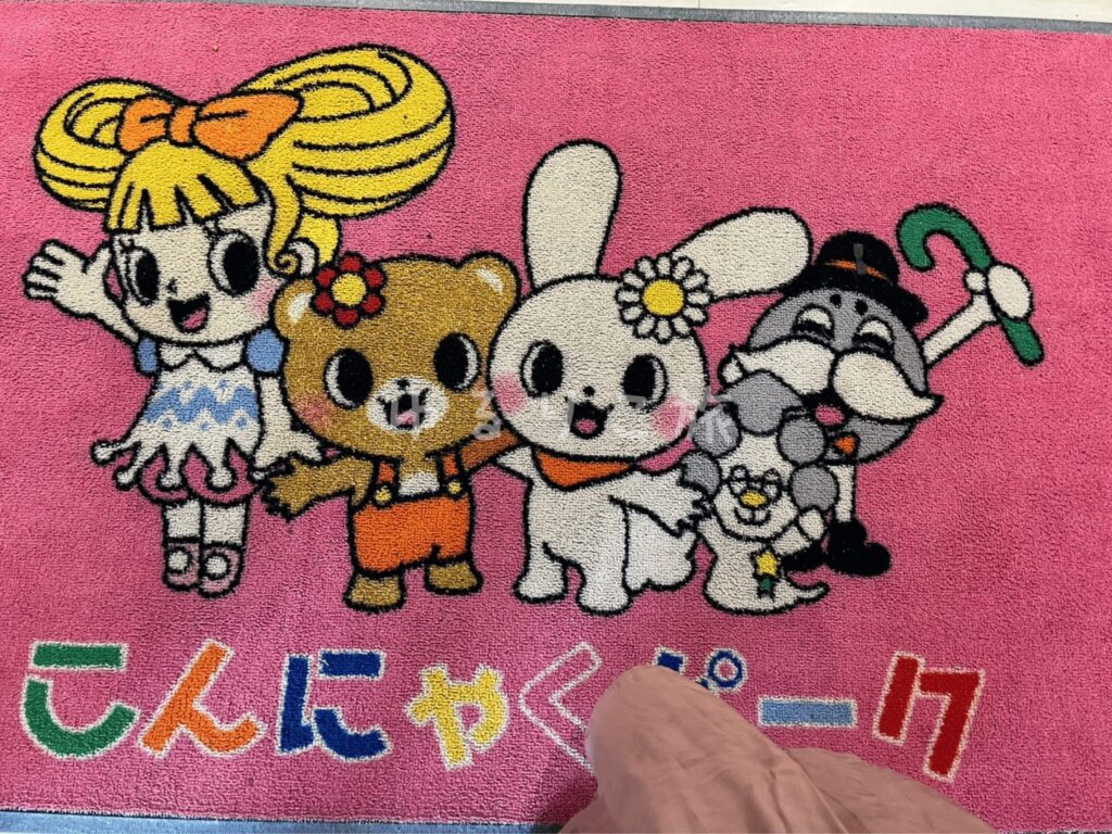 こんにゃくパークのキャラクターが描かれた入口マット